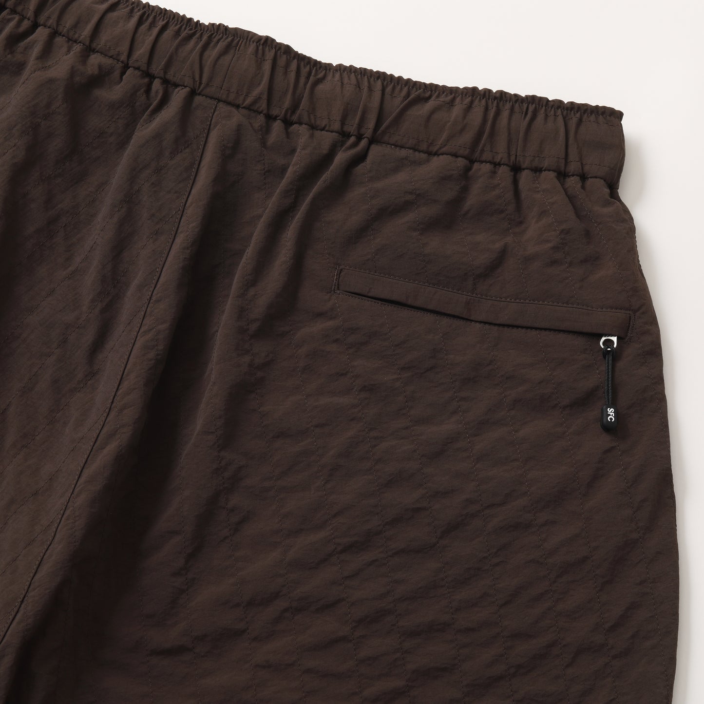 S.F.C NEW WIDE TWO TUCK PANTS (STITCHED NYLON) D BROWN【SFCFW25P06】(N)