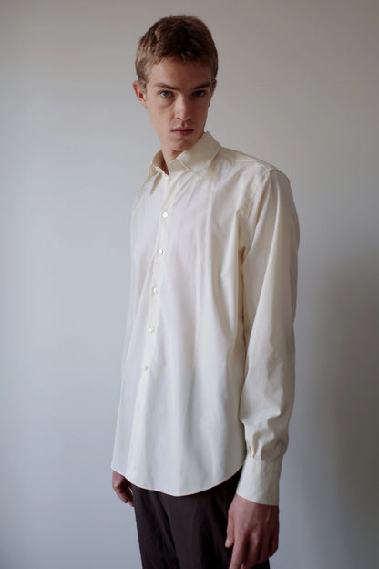 CAMISAS MANOLO（カミサス マノロ）Normal Shirt Pale Yellow Black Stripesの斜め前からの着用画像。淡いイエローのストライプシャツで、ゆとりのある身幅と自然な生地のドレープ、襟元のディテールが確認できる。