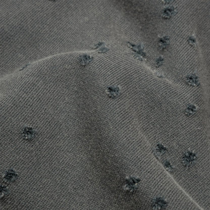 SATISFY MothTech™ Hoodie Faded Blackの生地ディテール。オーガニックコットン素材に施されたMothTech™の通気孔と風合い。